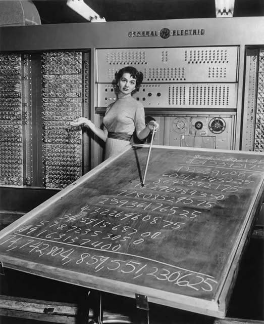 1955 Woman with a General Electric mainframe computer and a blackboard.jpg