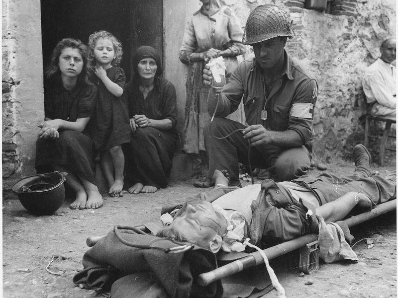 is_being_given_blood_plasma_after_he_was_wounded_by_shrapnel_in_sicily_on_8-9-43_-_nara_-_197268.jpg