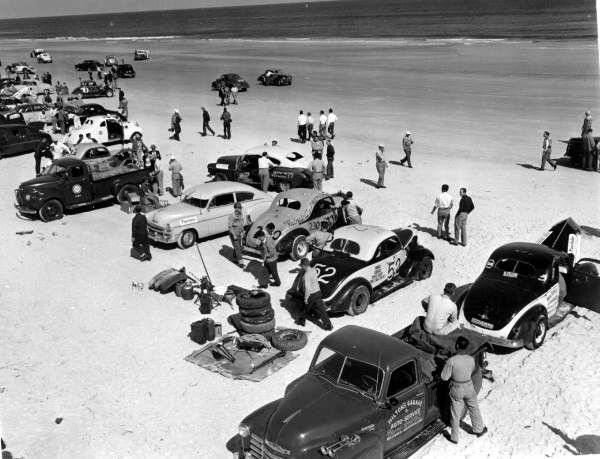 Stock cars racing or waiting to race with pickup trucks in Daytona Beach, Florida in the fifties.jpg